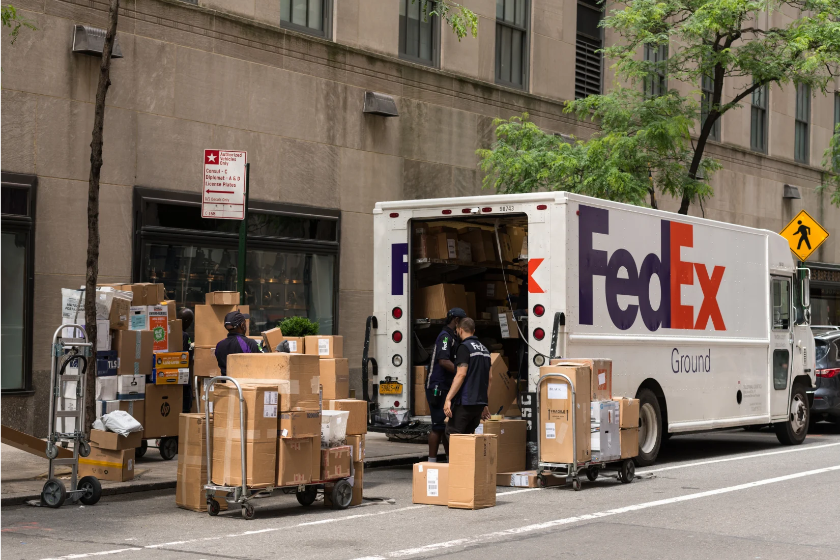 FedEx Ground delivery truck loading packages for e-commerce fulfillment